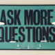 The words ask more questions as a framed picture on a wall