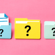 Three file icons on a pink background with a question mark on the front of each file