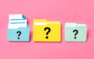 Three file icons on a pink background with a question mark on the front of each file