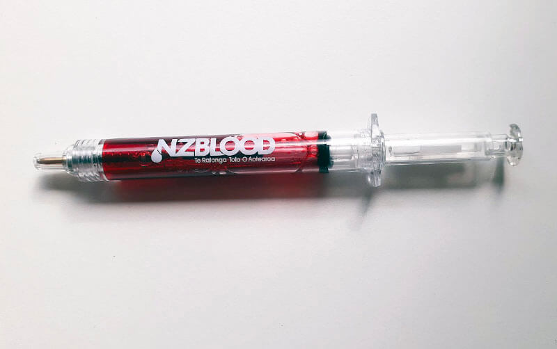 pen in the shape of a syringe with red blood as ink