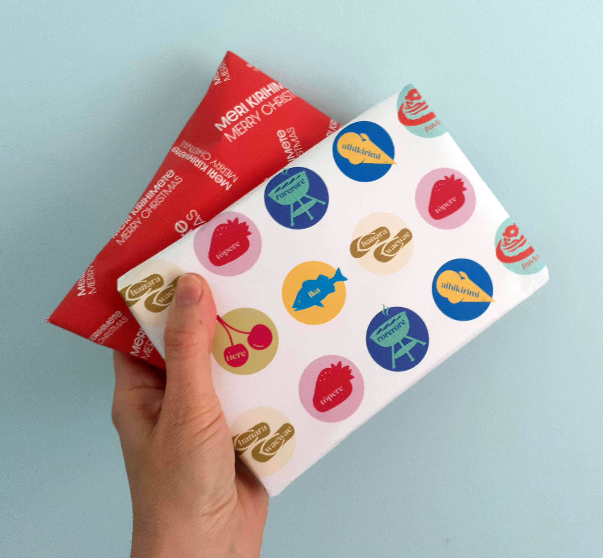 hand holding two small gifts wrappedin paper